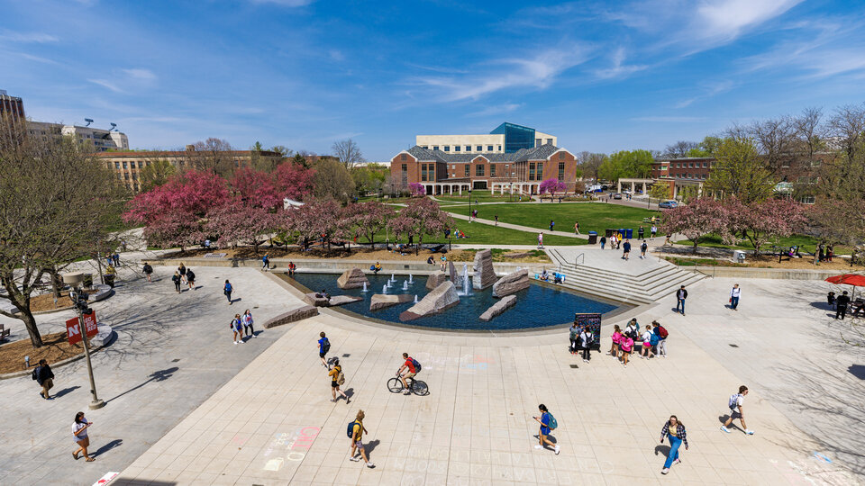 Students walk across the plaza on the North side of the Nebraska Union by the Broyhill fountain.